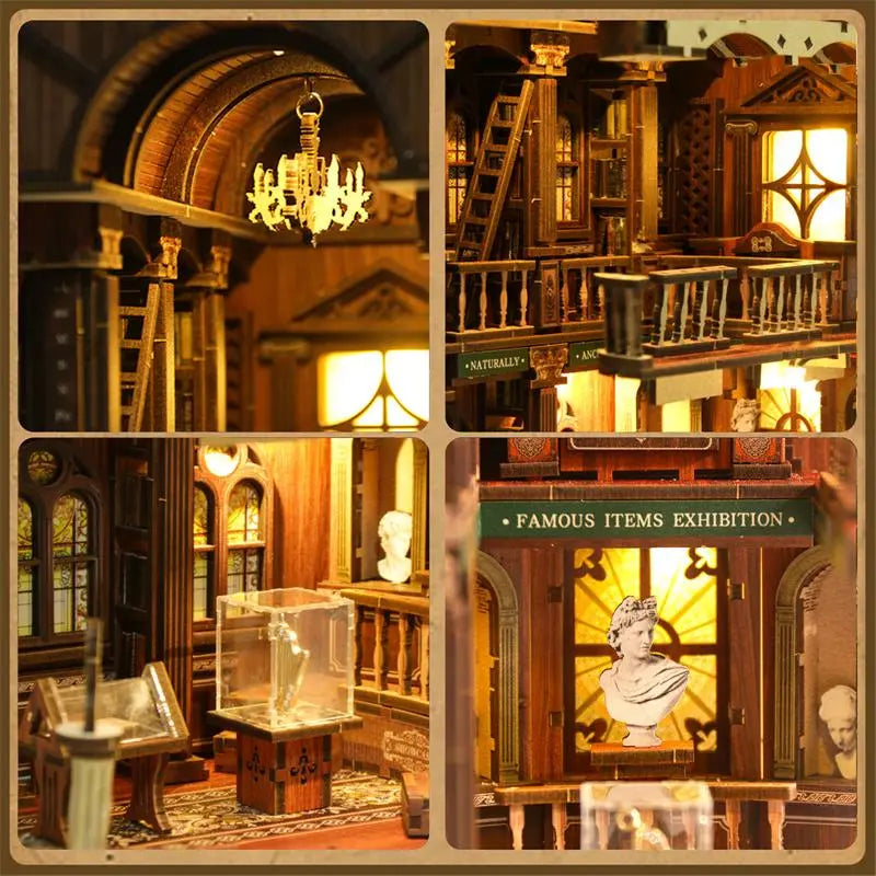 Miniature glass display case in center of first floor inside【The Philosophica Library】， clear acrylic enclosed on four sides, housing three plaster sculptures： Socrates bust on left, Venus de Milo in center, Homer bust on right, each approximately 2cm tall, with matte granular texture simulating plaster