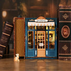 【Pergola Reading Room】 European vintage bookstore miniature model display | Deep sea blue frame with beige striped awning, sandwiched between classic dark books, paired with a miniature cat figurine at the door, creating a serene reading atmosphere | Minipata
