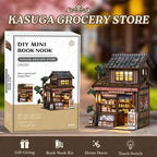【Kasuga Grocery Store】 DIY miniature model fully assembled, showing front two-story pitched roof, dark gray tile texture, openable sliding doors with lattice windows, and red lanterns on lintel