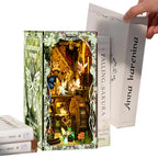 【Secret World of the Forest】 can be held in one adult hand, size comparison with a hand and the book Anna Karenina, intuitively showing the book nook's height of approx. 23cm, perfect for shelf or desk placement