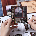 Two pairs of hands assembling【Moss-Lantern Harmony Garden】 on a bright desk, one using tweezers to insert miniature books into shelf, the other gluing shoji paper onto door frame grilles against the manual