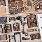 Dark brown desk by the window on left side of second floor inside【Kasuga Grocery Store】， items on desk： miniature ink bottle (black body with gold sticker), dip pen with metallic nib, a small open ledger with red and blue micro-printed numbers, a matching wooden chair beside it with faux rattan pattern on backrest