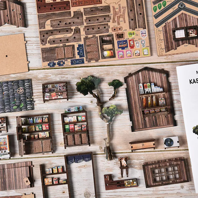 Dark brown desk by the window on left side of second floor inside【Kasuga Grocery Store】， items on desk： miniature ink bottle (black body with gold sticker), dip pen with metallic nib, a small open ledger with red and blue micro-printed numbers, a matching wooden chair beside it with faux rattan pattern on backrest