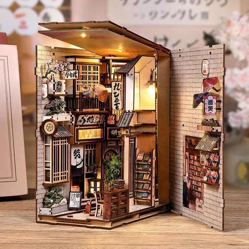 The Alley Waiting for the Cat book nook wooden gift box packaging alongside assembled product – laser-engraved maneki-neko logo, Japanese alley miniature book nook diy kit gift set
