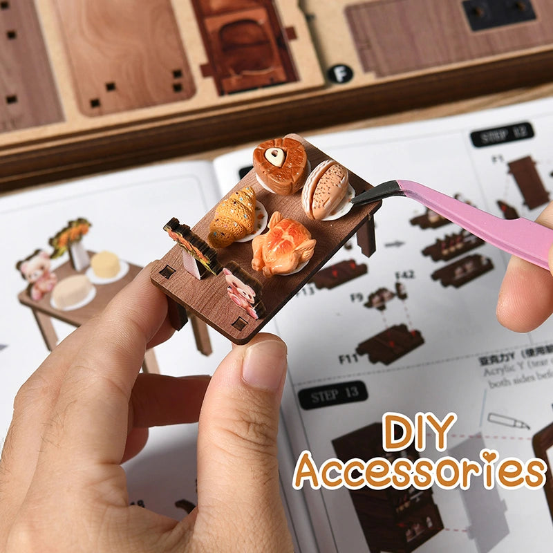 Bear Restaurant DIY miniature house accessories detail – hand placing miniature bear figurine and food props, showing the fine craftsmanship of handcrafted wooden café accessories including bread basket, succulents and dining chairs
