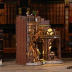 Dreamy Book Hall DIY miniature house displayed on a bookshelf – side profile showing multi-story wooden library tower with warm amber LED glow through arched windows, functional bookend display
